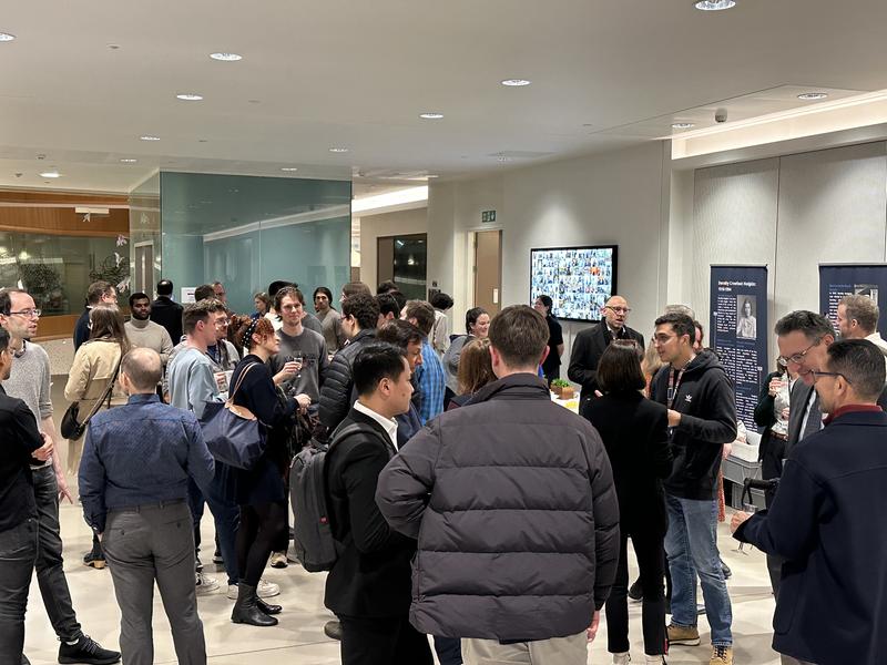 A group photo of Kavli researchers enjoying the drinks reception