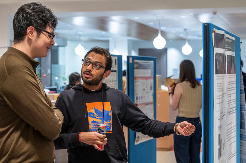 Dr Saurabh Talele and Zile Zhuang (Doctoral Student) discussing academic posters at the 5th birthday symposium held by Oxford's Kavli Institute for Nanoscience Discovery (Kavli INsD)