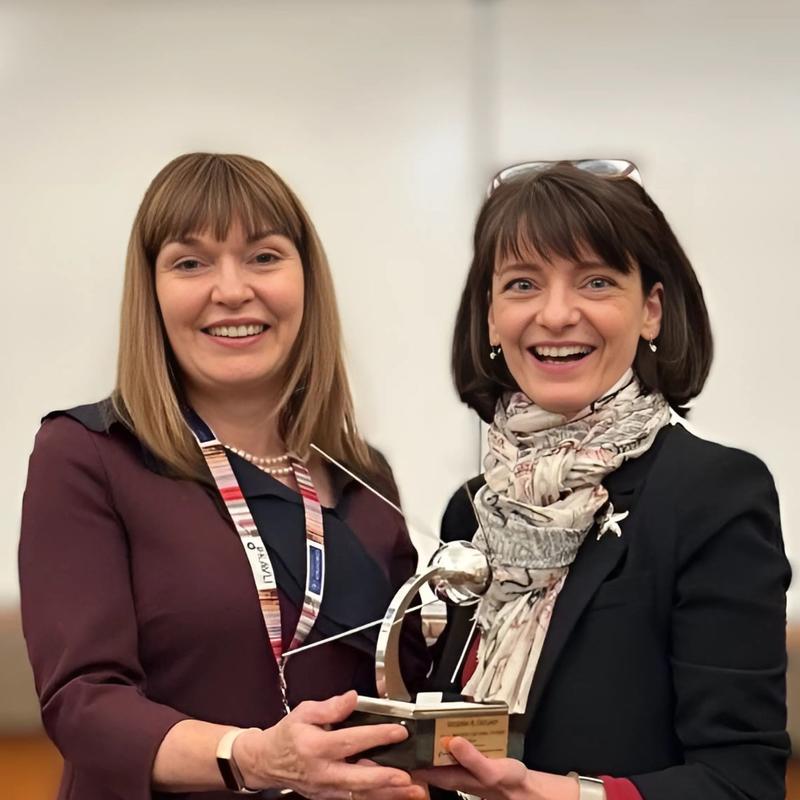 a photo of carol and regina with the award